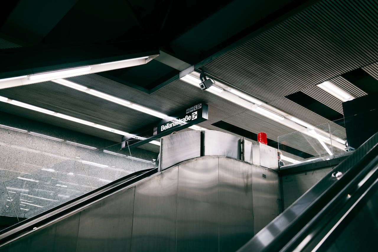 Sleek modern subway station interior in Berlin featuring escalators and minimalistic design elements.